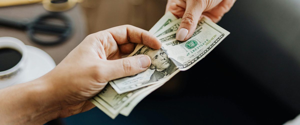 Two individuals engaged: one delivering payday loan funds in Maryland. Explore the appeal of Payday Loans Online Maryland today.